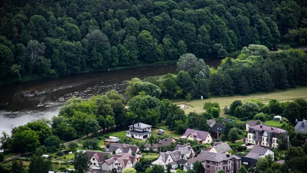 Vaizdas iš viršaus į Neries upę ir šalia jos įsikūrusius gyvenamuosius namus.
